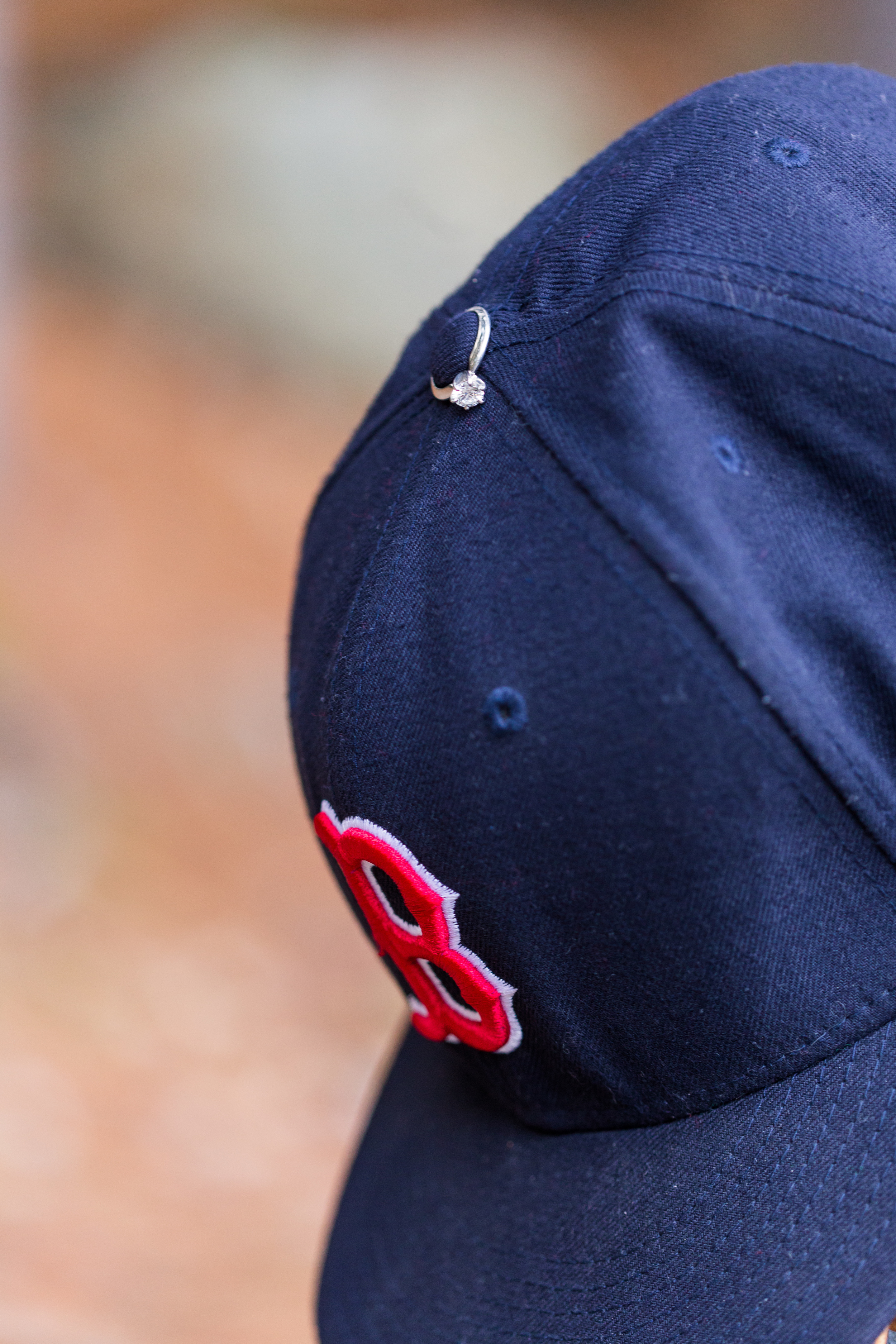 engagement ring on Boston Red Sox baseball hat 