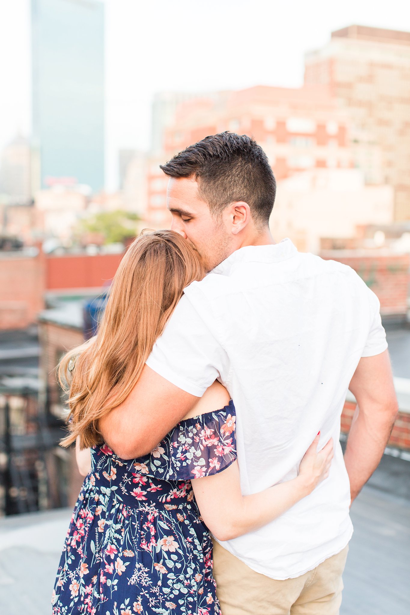 couple standing on Boston rooftop