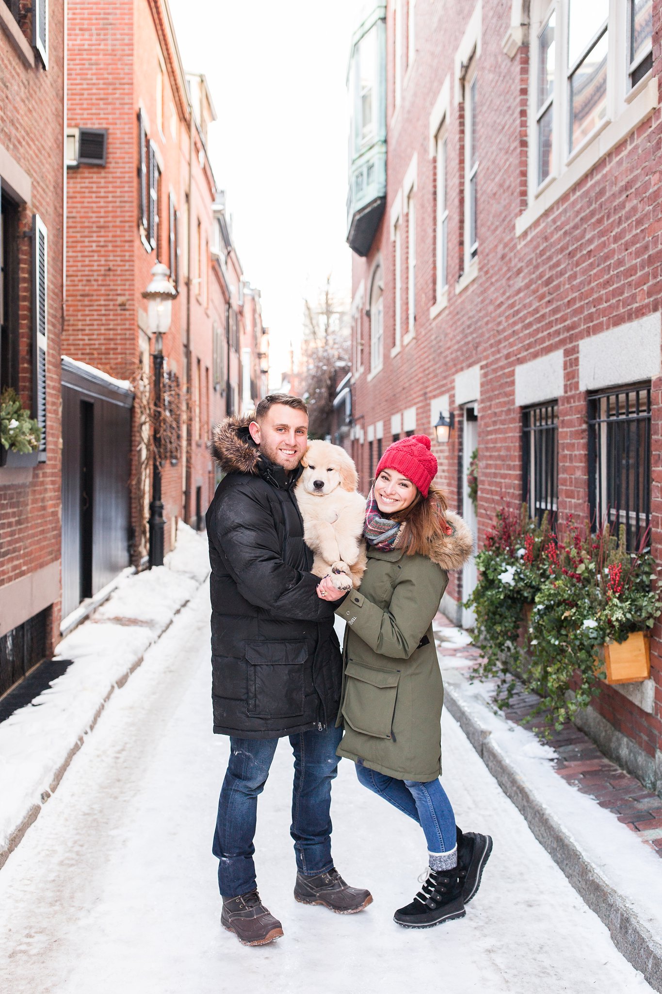 two people holding a puppy in the streets of Beacon Hill, Boston