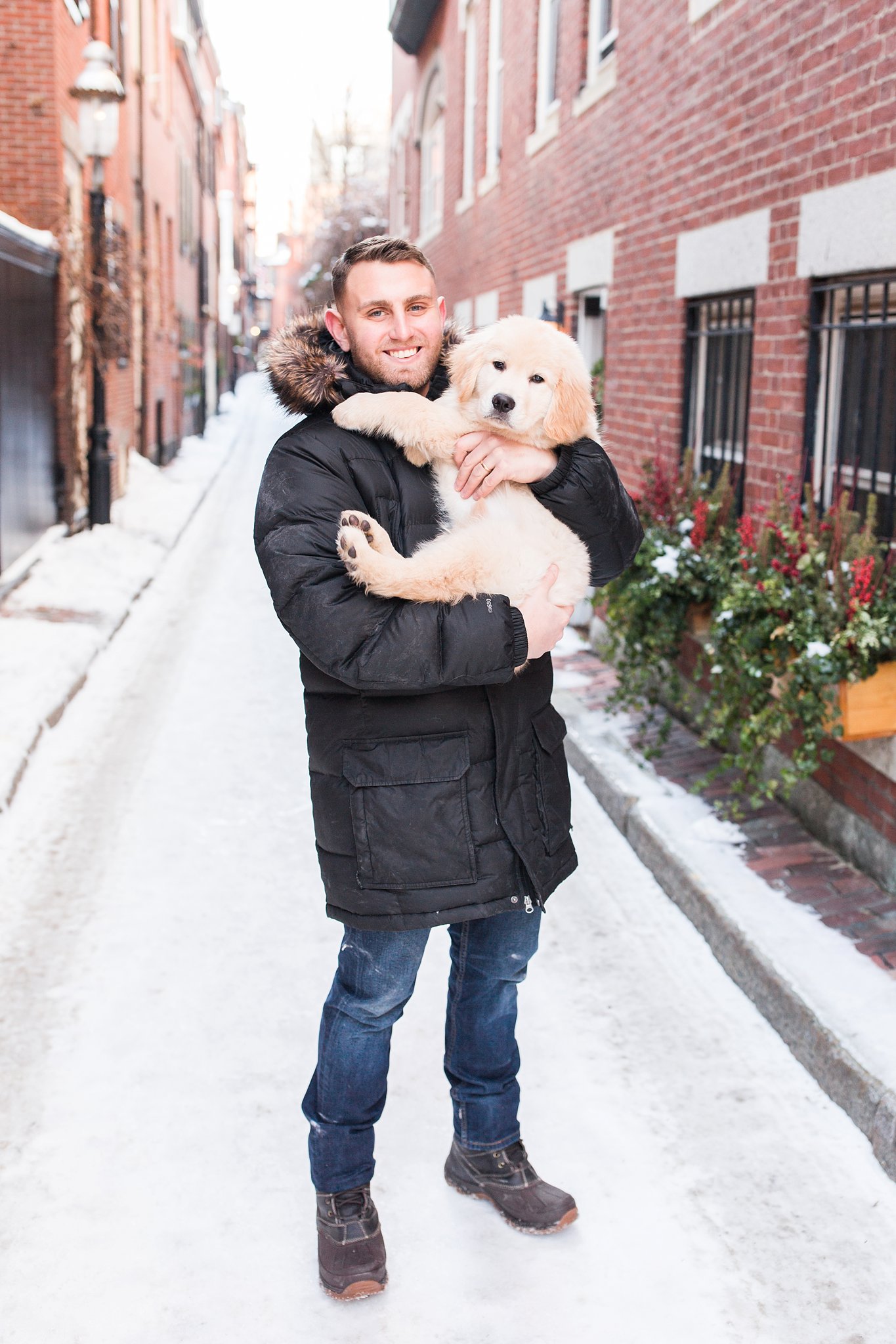 man holding golden retriever puppy in the streets of Beacon Hill, Boston