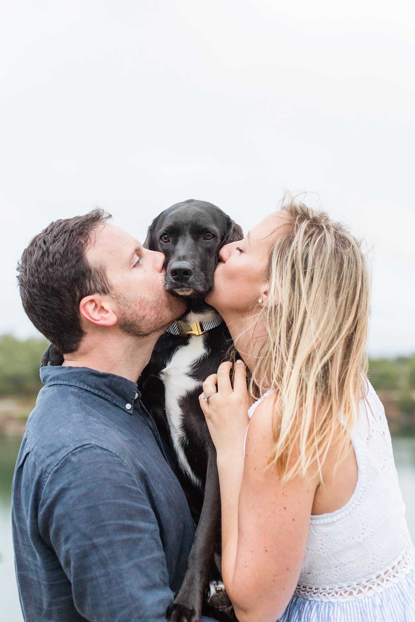 couple kissing their dog at halibut point state park