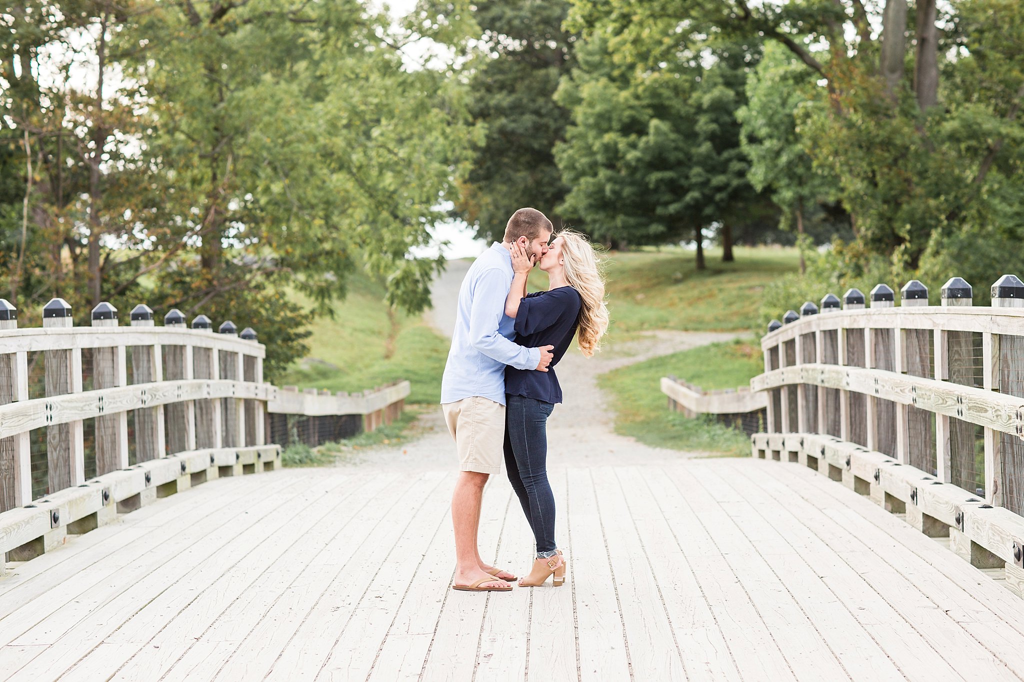 couple kissing on a bridge at World's End in Hingham, MA