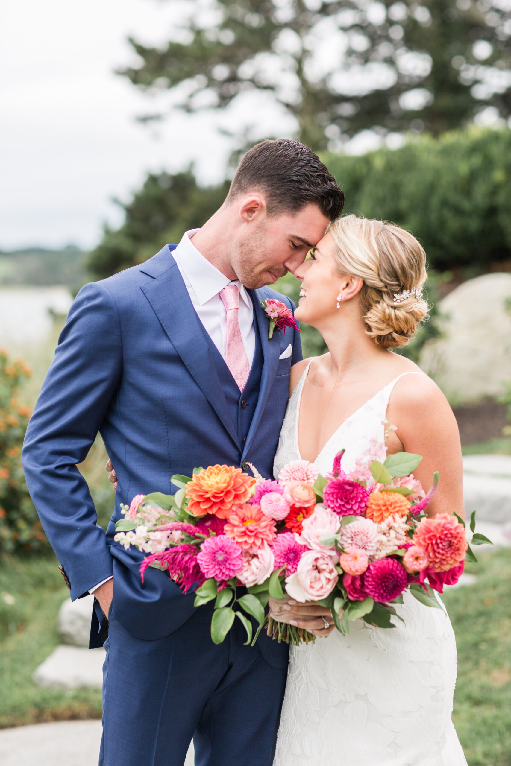 Bride and groom touching foreheads for wedding photos