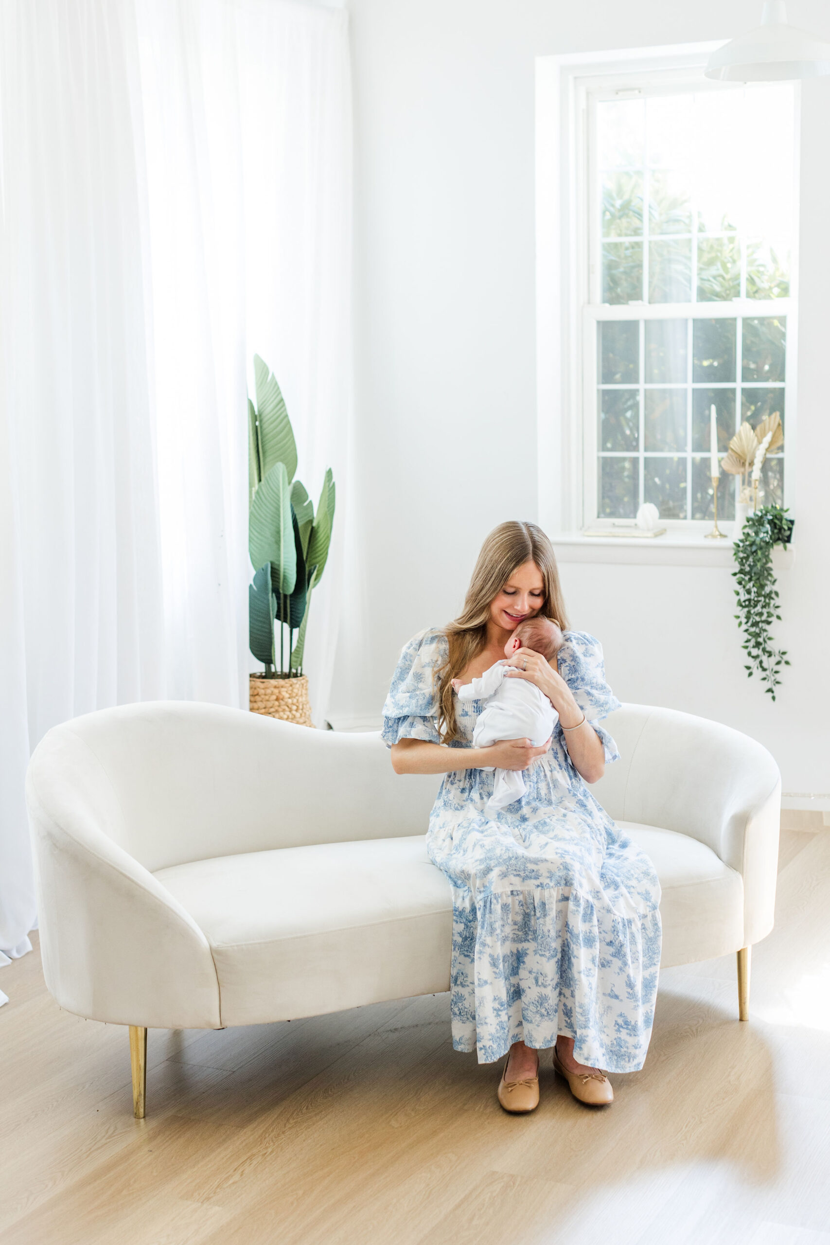 Mother holding her newborn baby in a studio