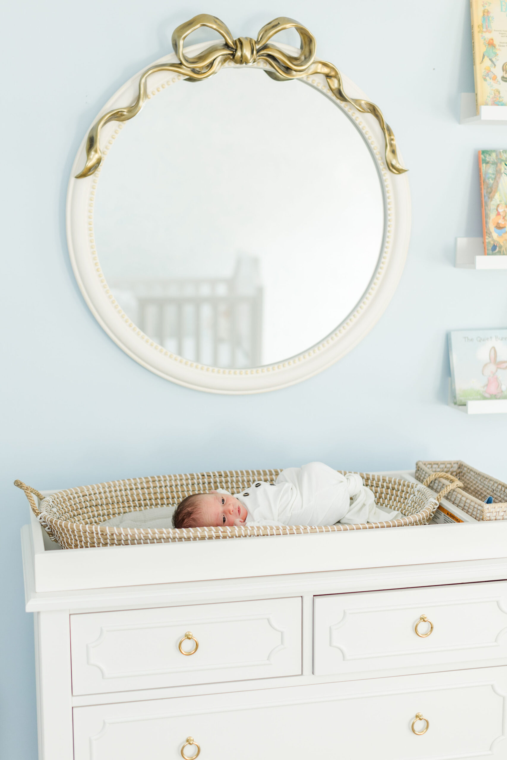 Newborn photoshoot at home with baby in her blue nursery