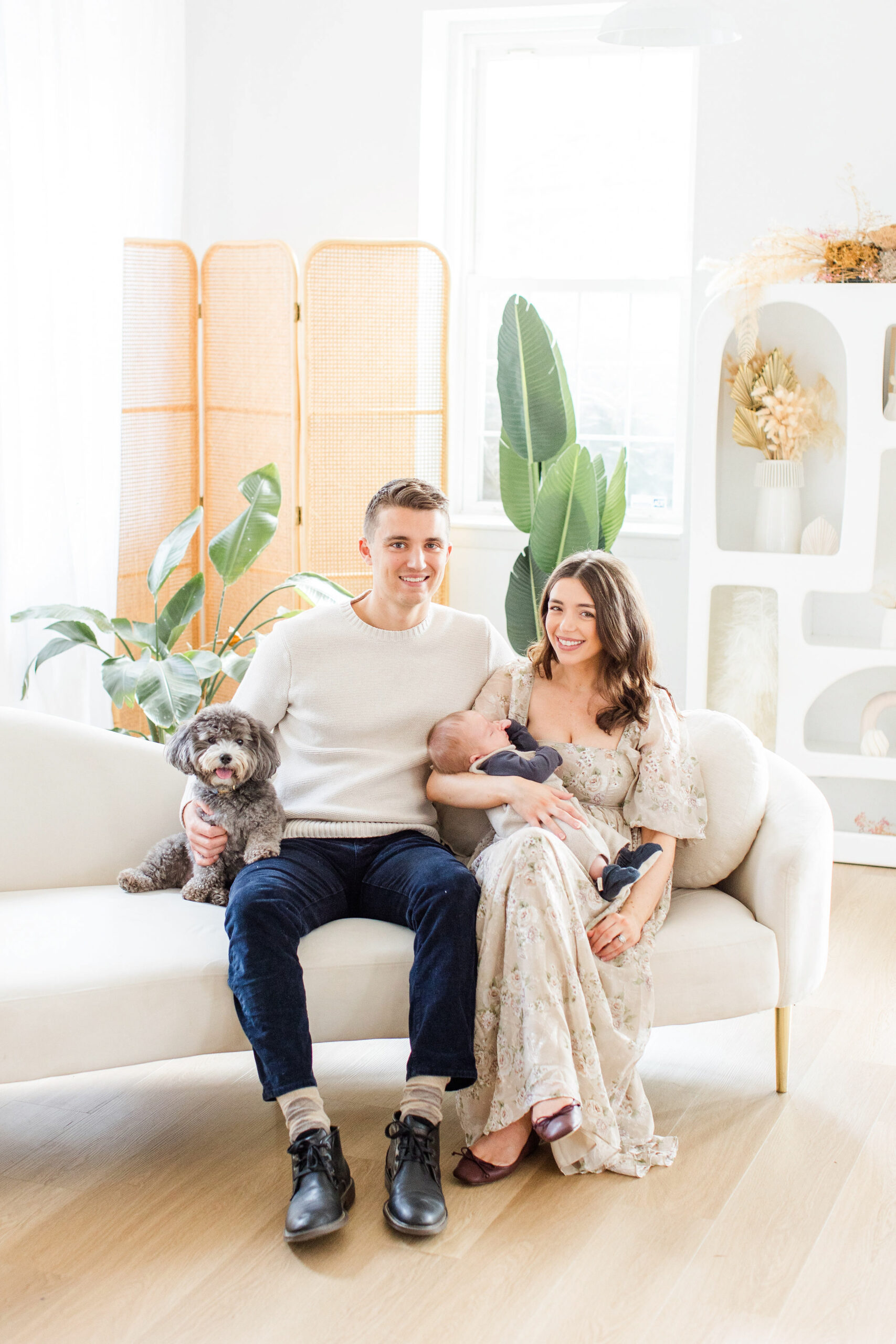 Family at a studio newborn photoshoot with dog