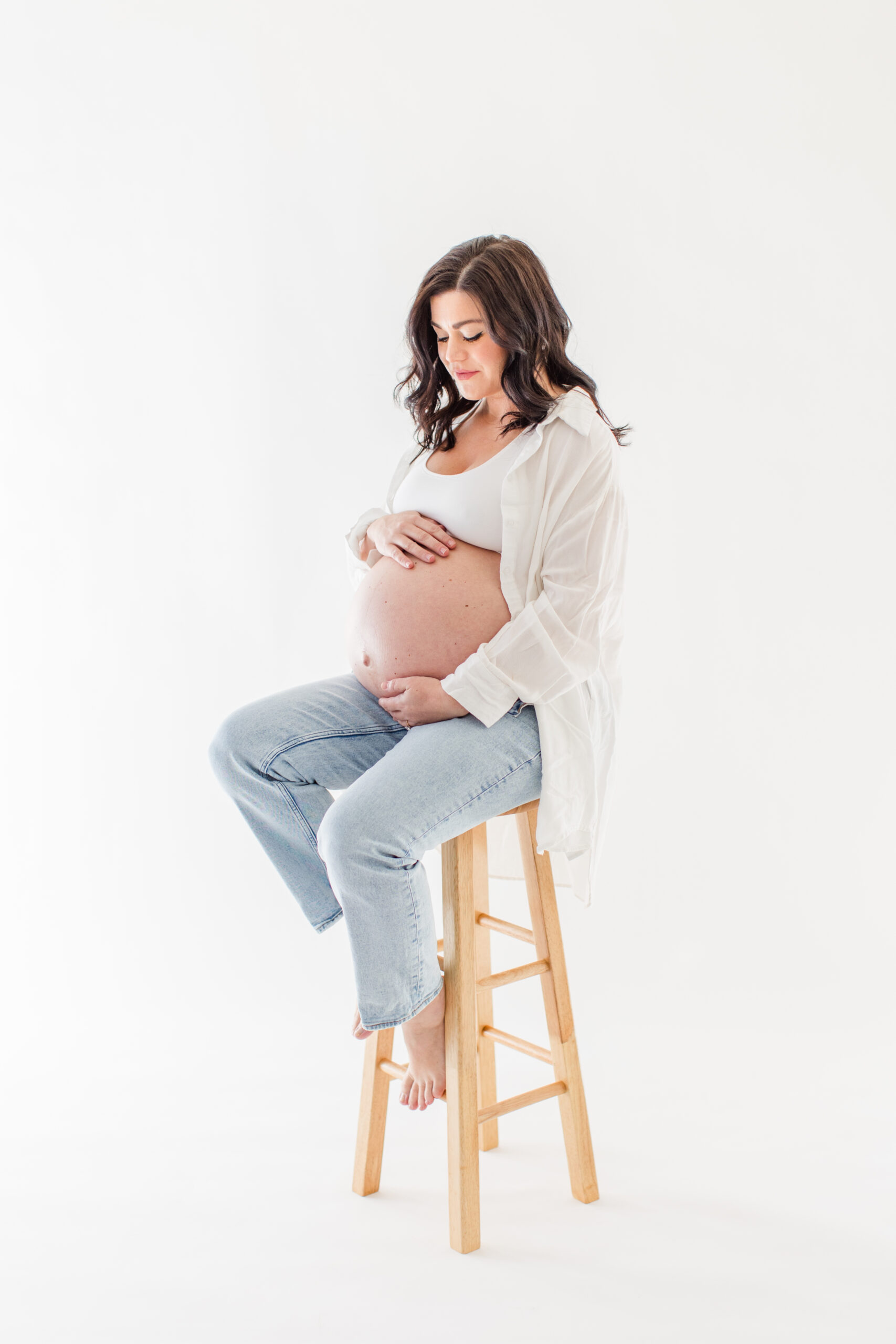 Mom taking maternity photos in a studio