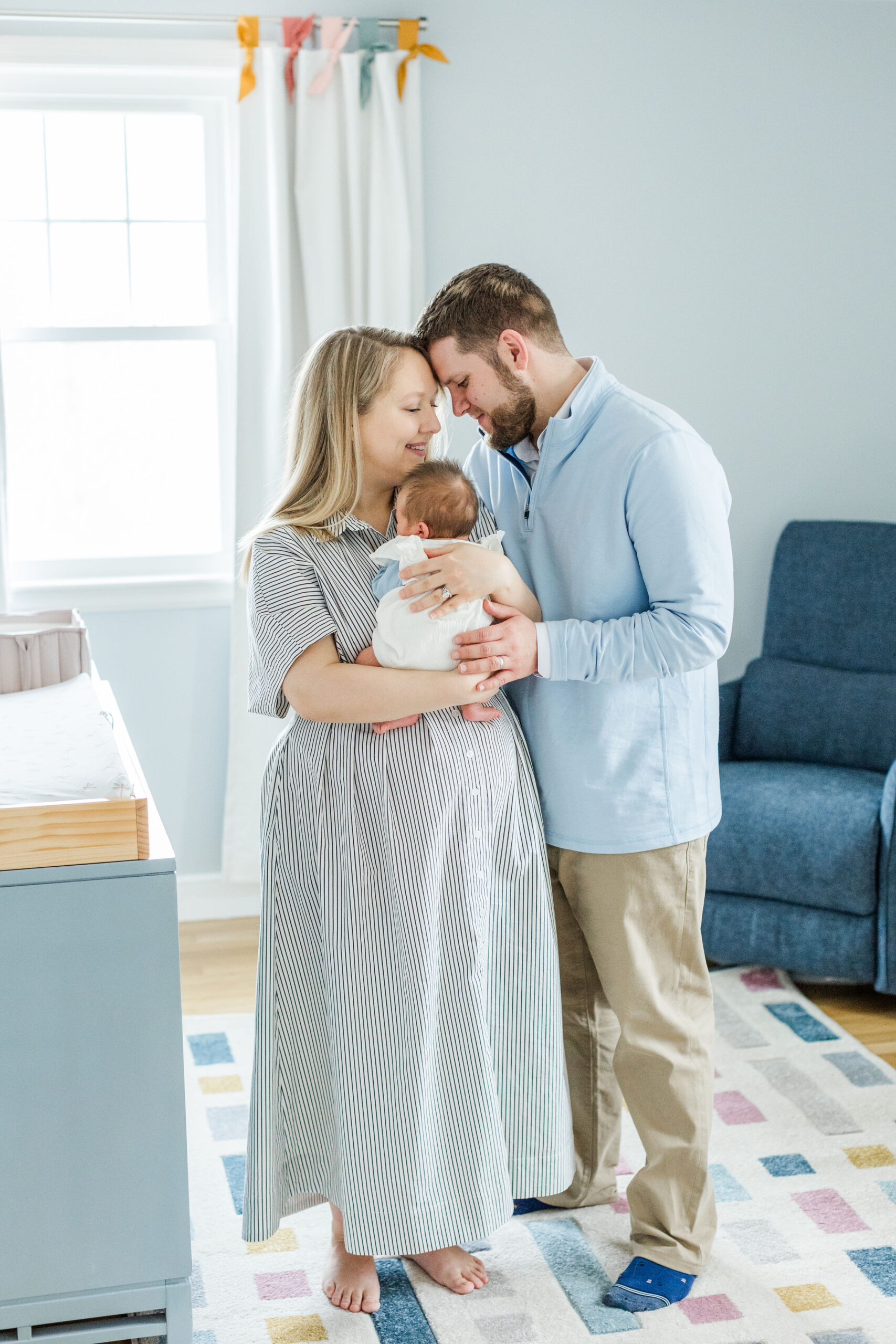 A family snuggling a newborn baby