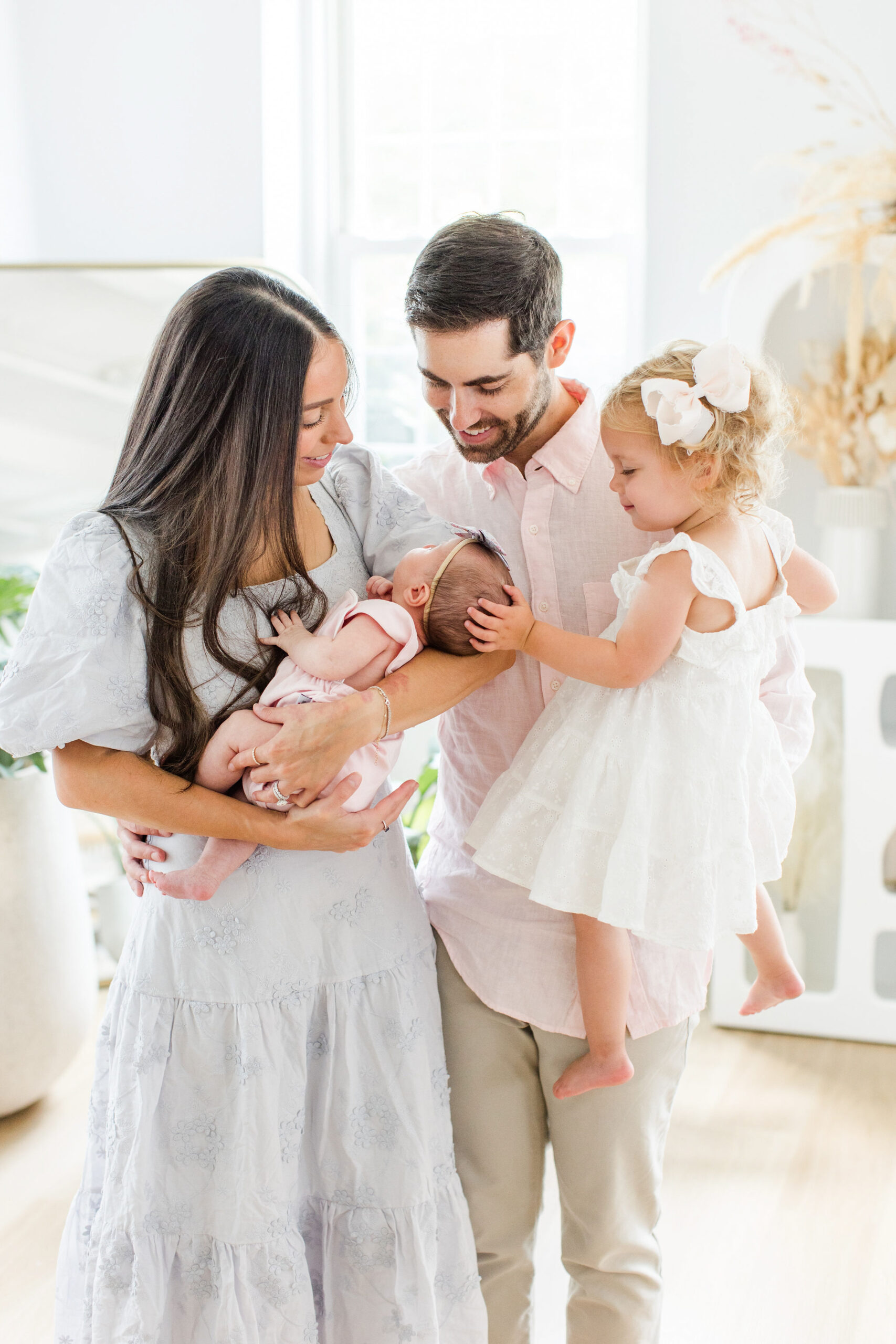 A family all looking at their newborn baby