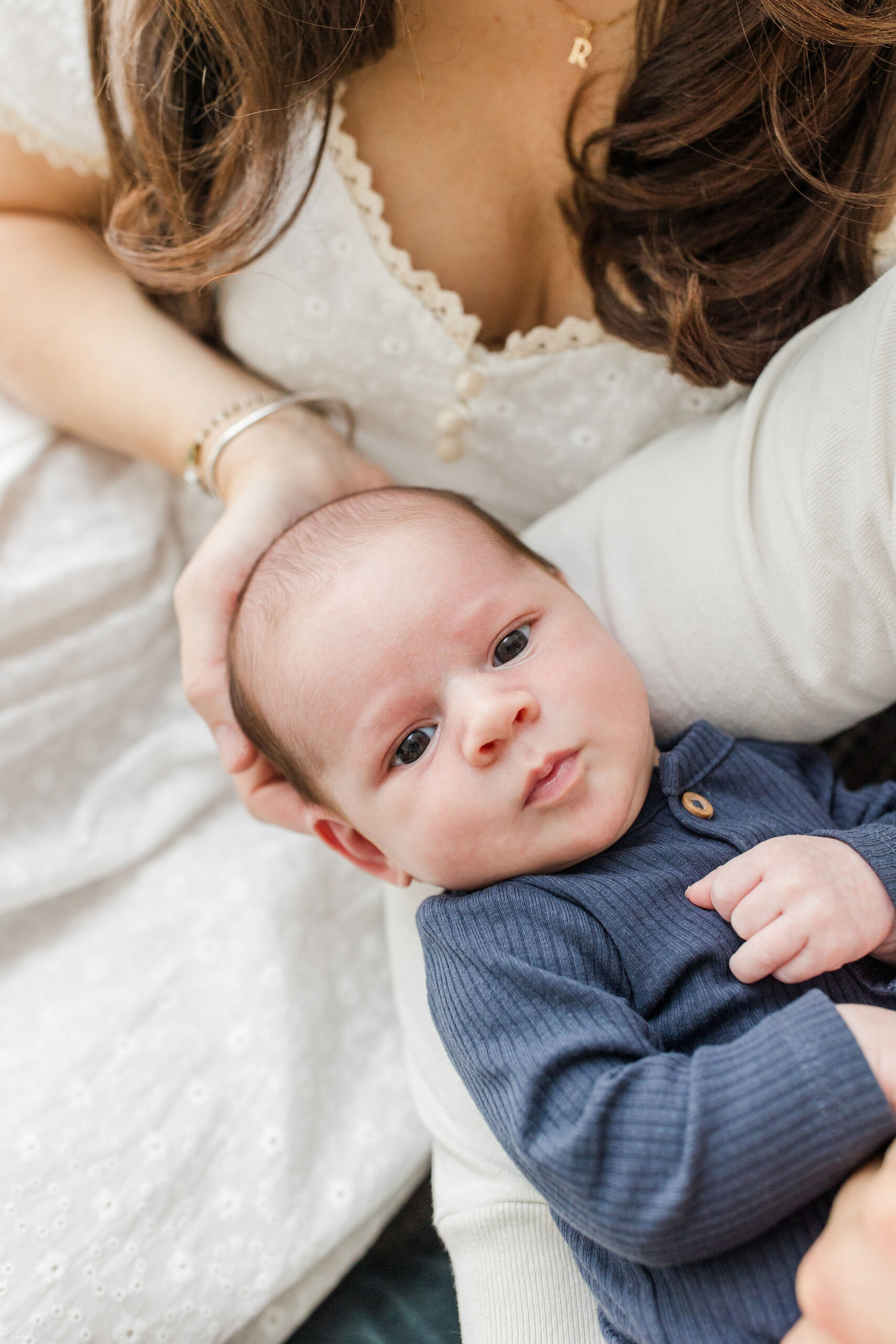 A baby boy looking at the camera in newborn photos