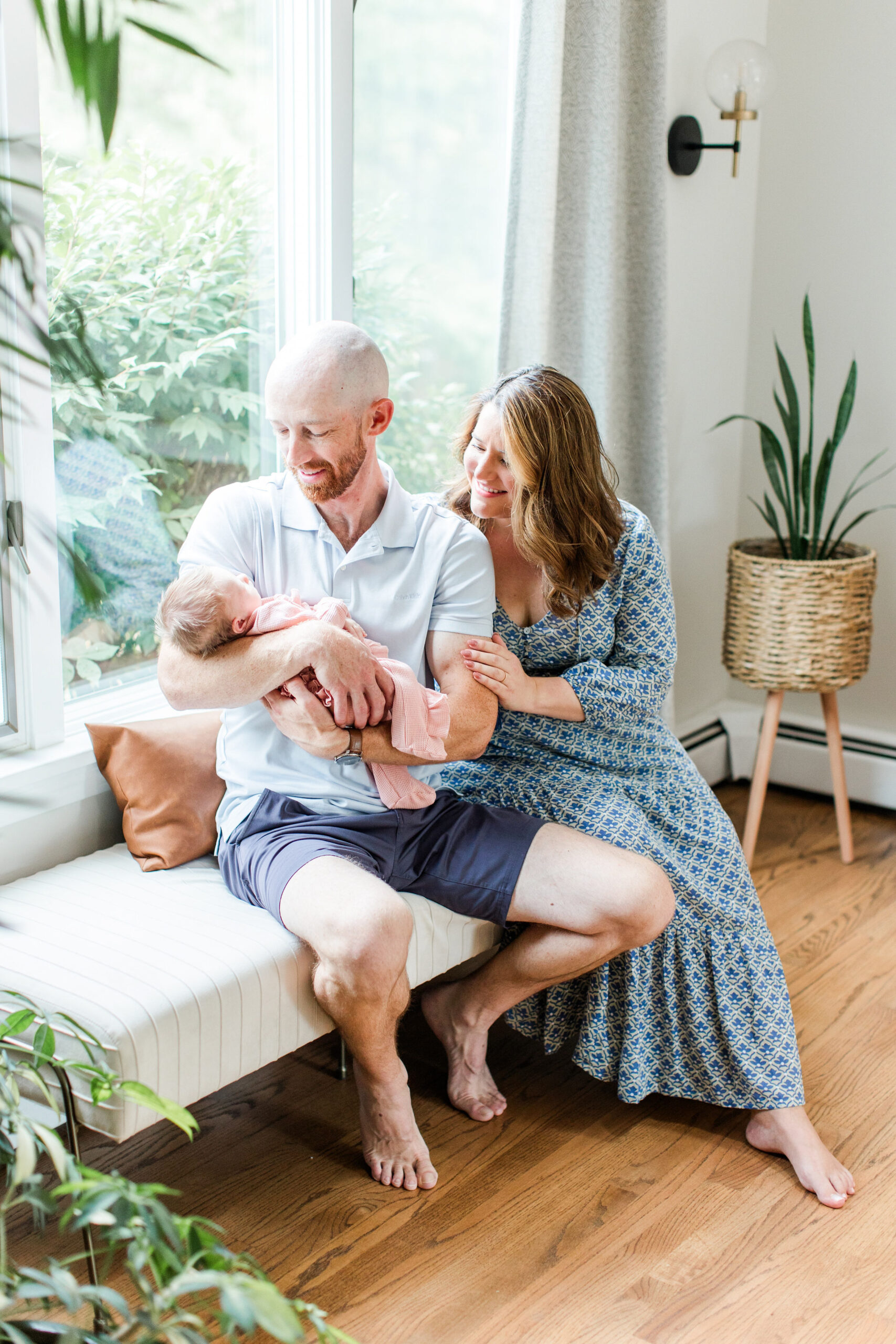 A mother and father looking at their newborn baby