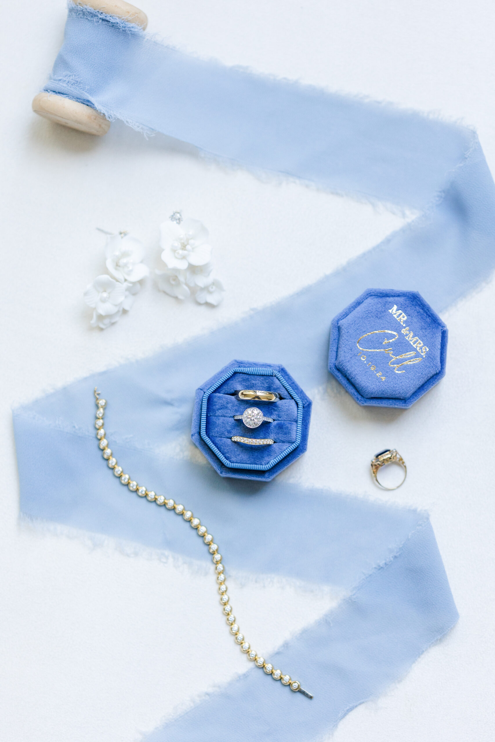 A blue wedding flatlay showing wedding details