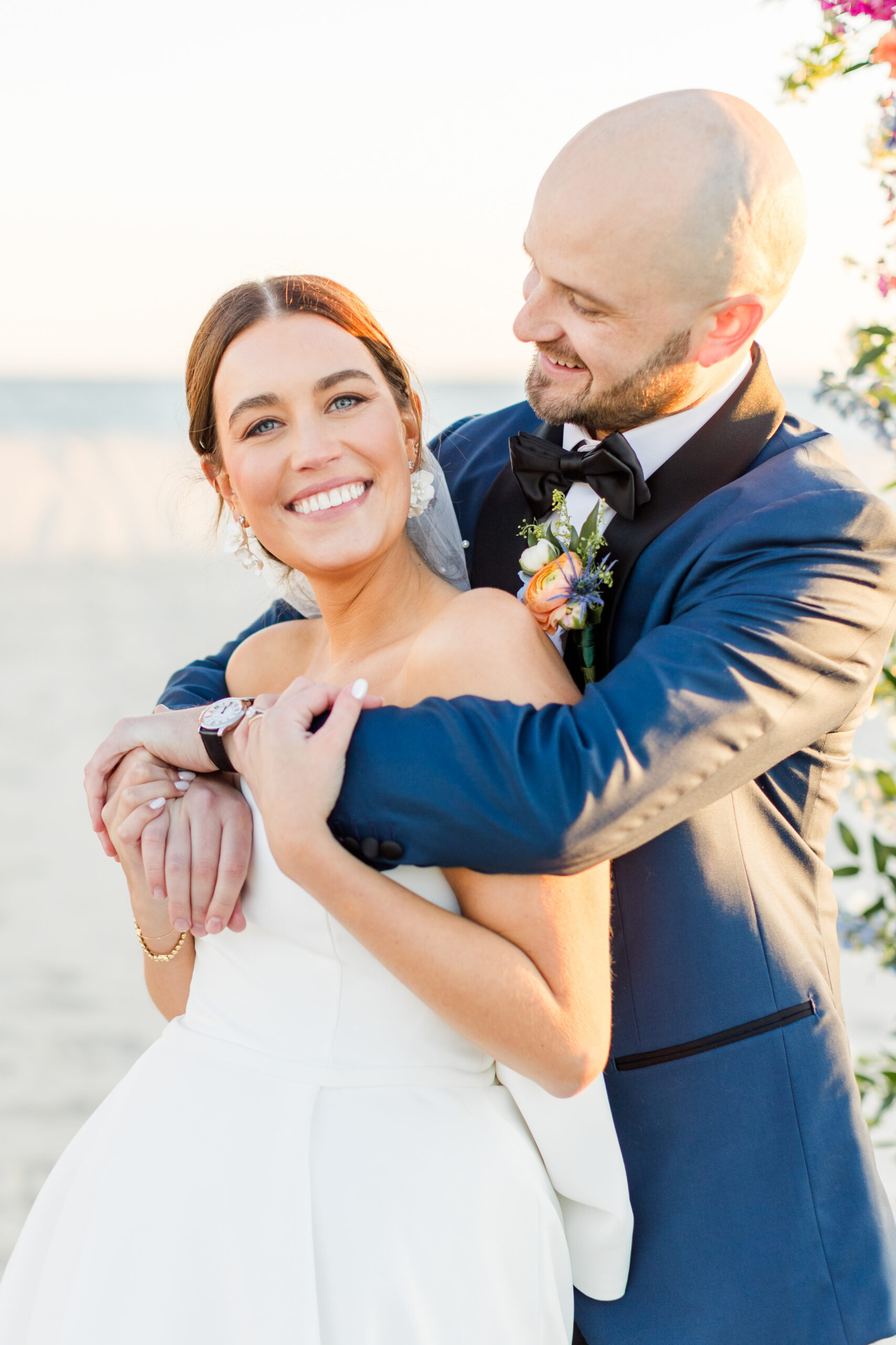 A bride and groom posing for beach wedding photos