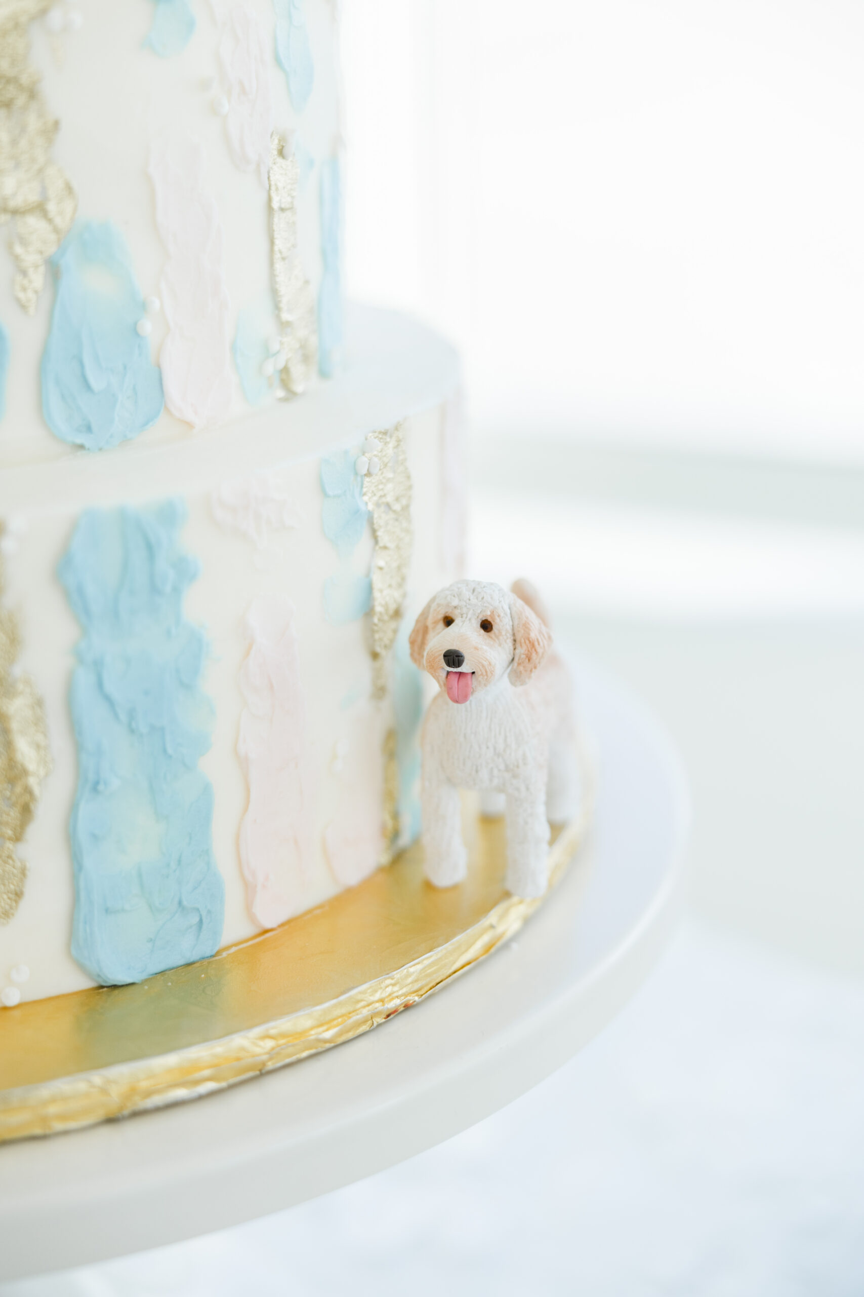 A wedding cake with a dog figurine