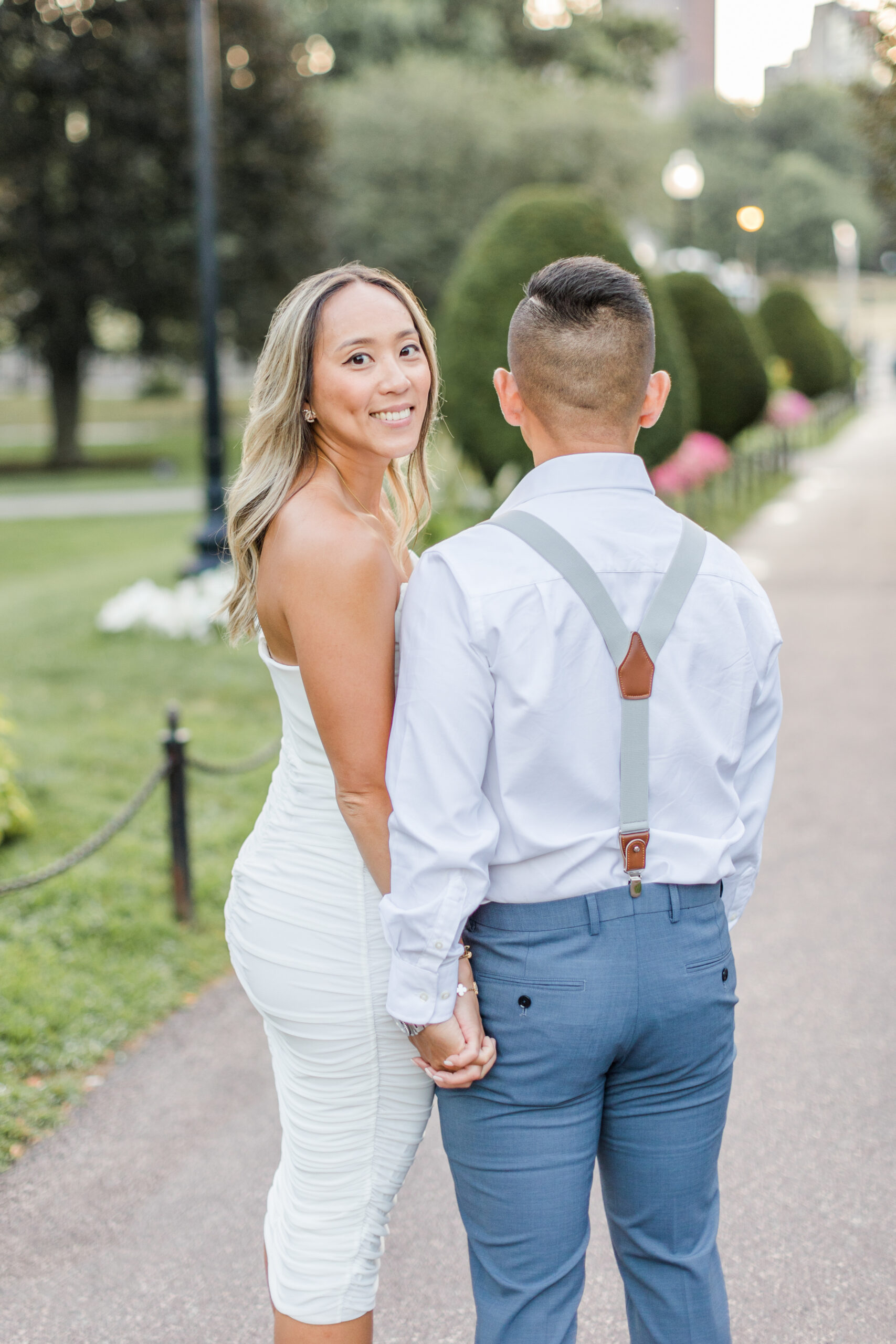A couple posing for Boston Public Garden engagement photos