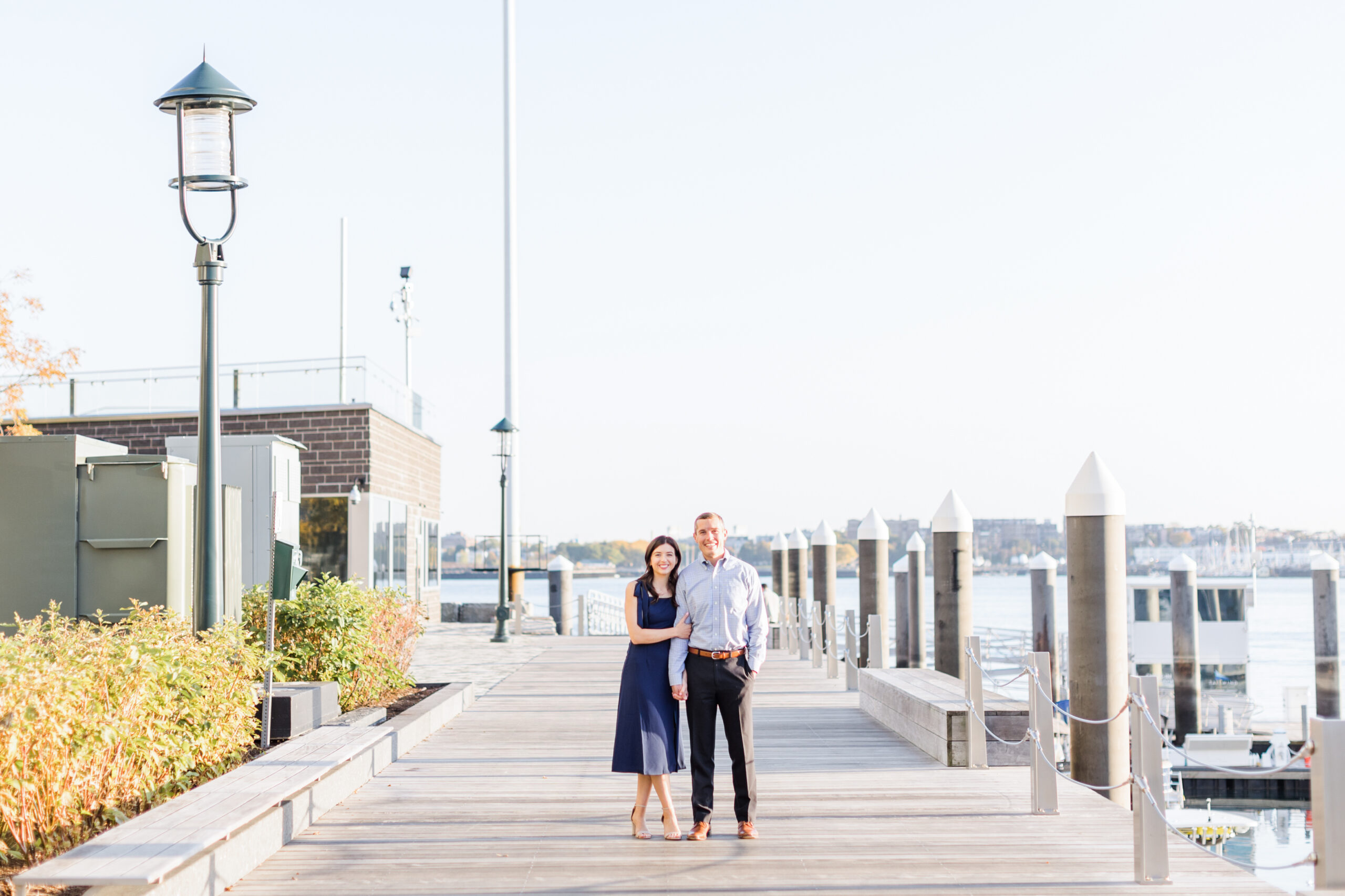A couple posing for engagement photos at a Boston engagement photo location, seaport
