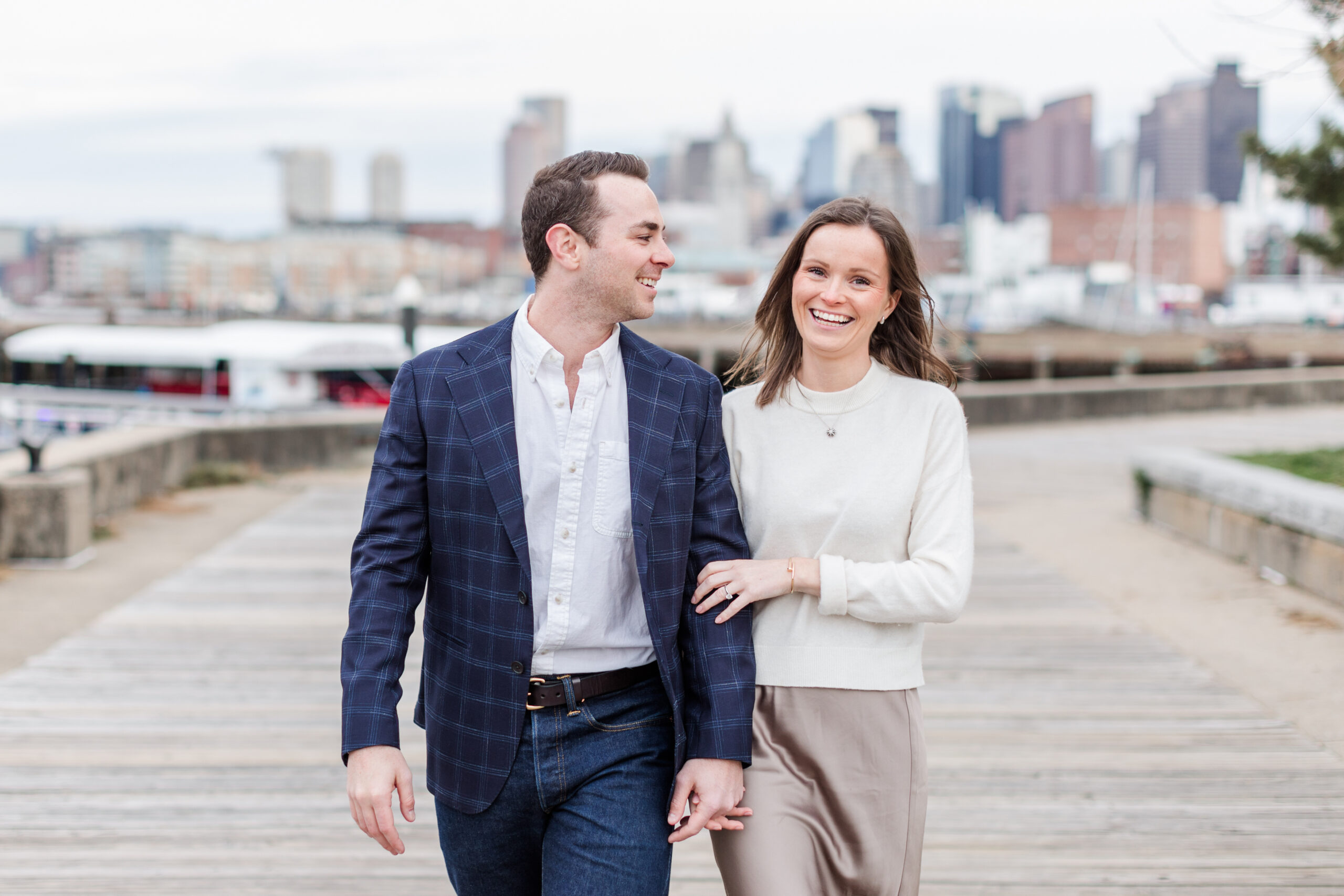 A couple walking through Charlestown for engagement photos