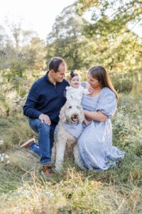 Man and woman with baby and dog during Boston family photos with dogs