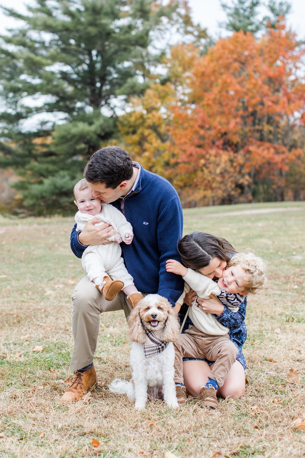 Man and woman with two children during their Boston family photos with dogs
